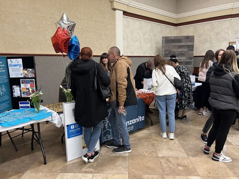 Community members visiting partner organization tables at an SSA community resource event.