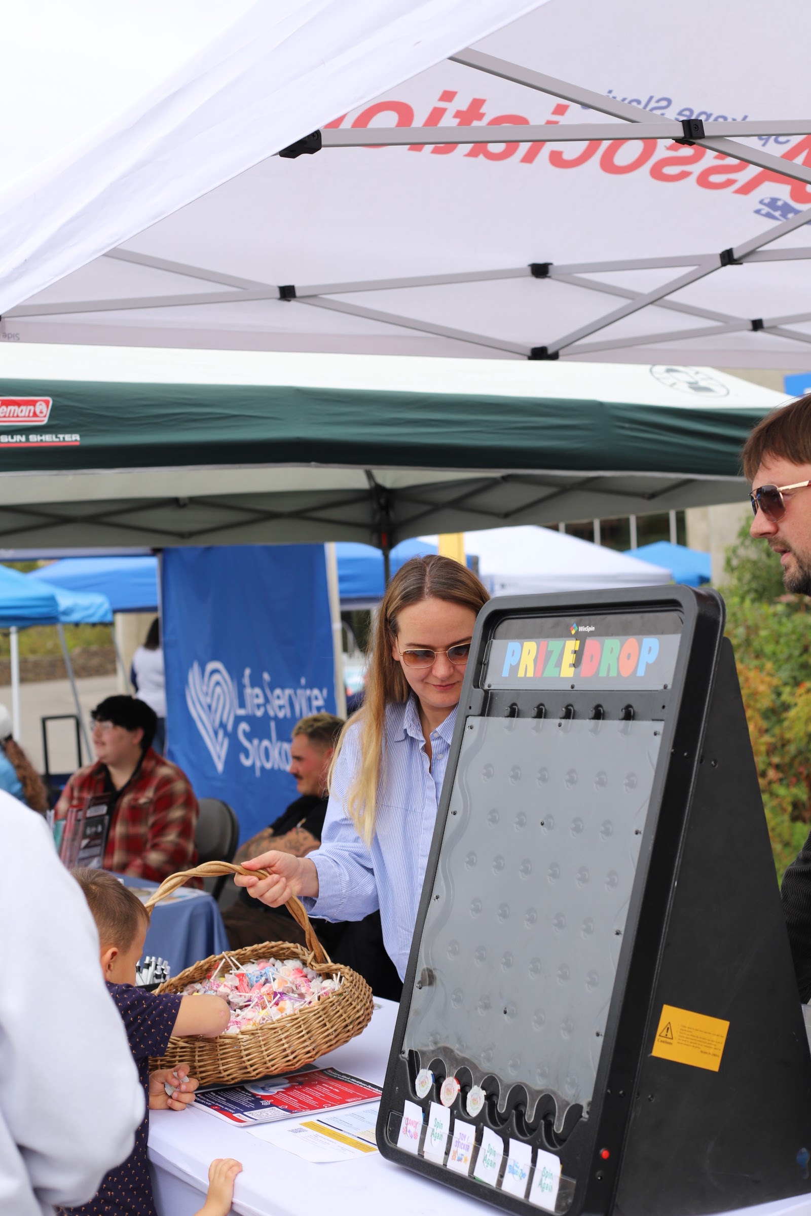 Partner organizations connect with families at their tables during Hands Across Spokane.