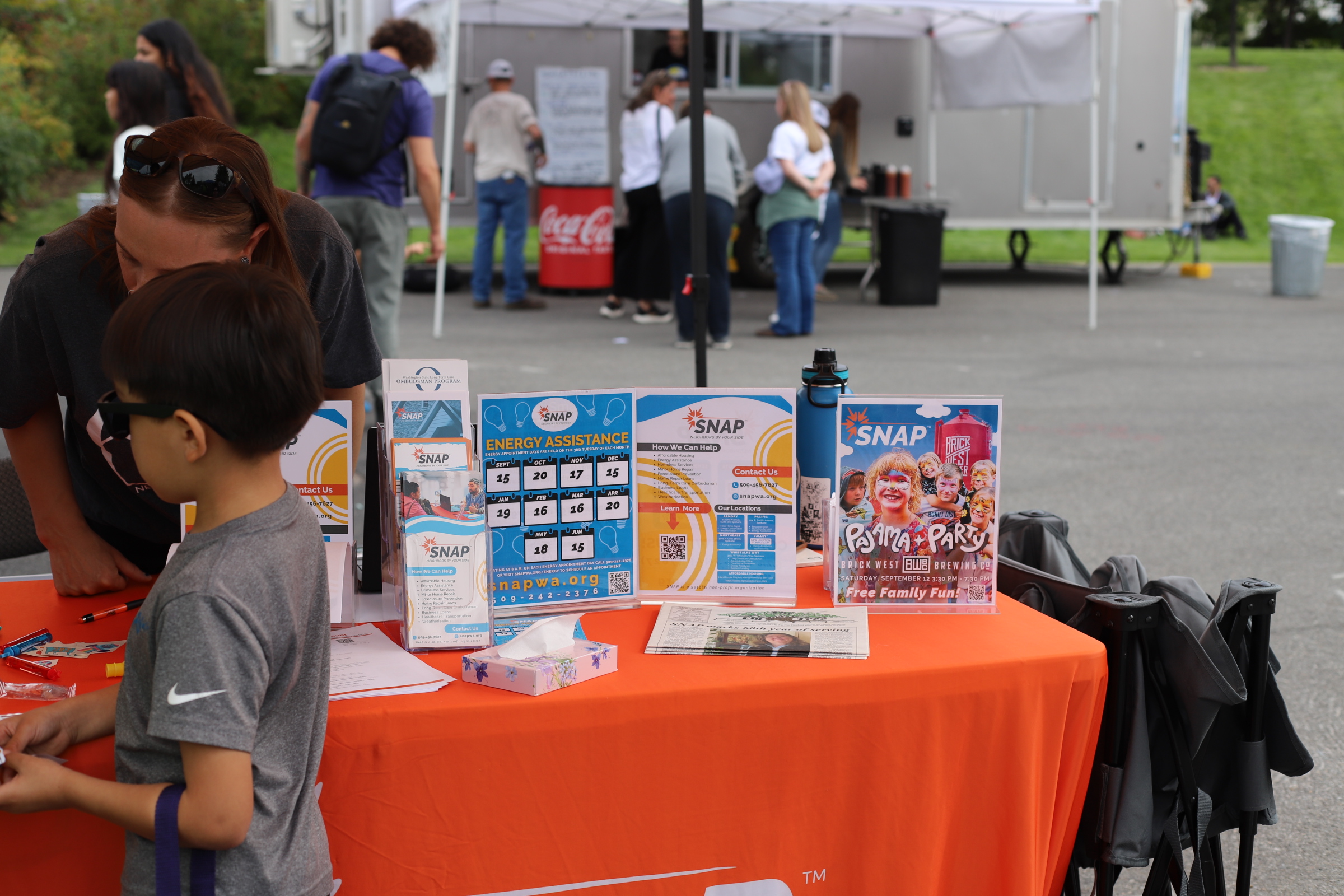 Partner organizations connect with families at their tables during Hands Across Spokane.