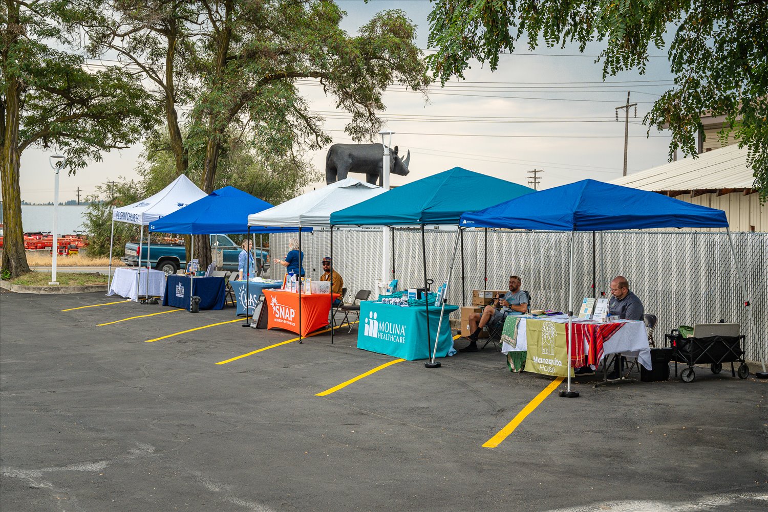 Community partner organization tents — SNAP, Molina Healthcare, Manzanita House — set up to connect people with resources at an SSA event.