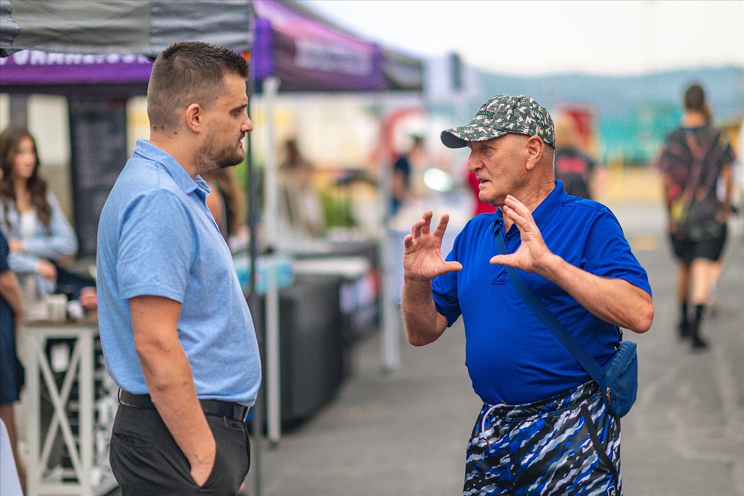 Community members and businesses gathered under a tent at an SSA event.