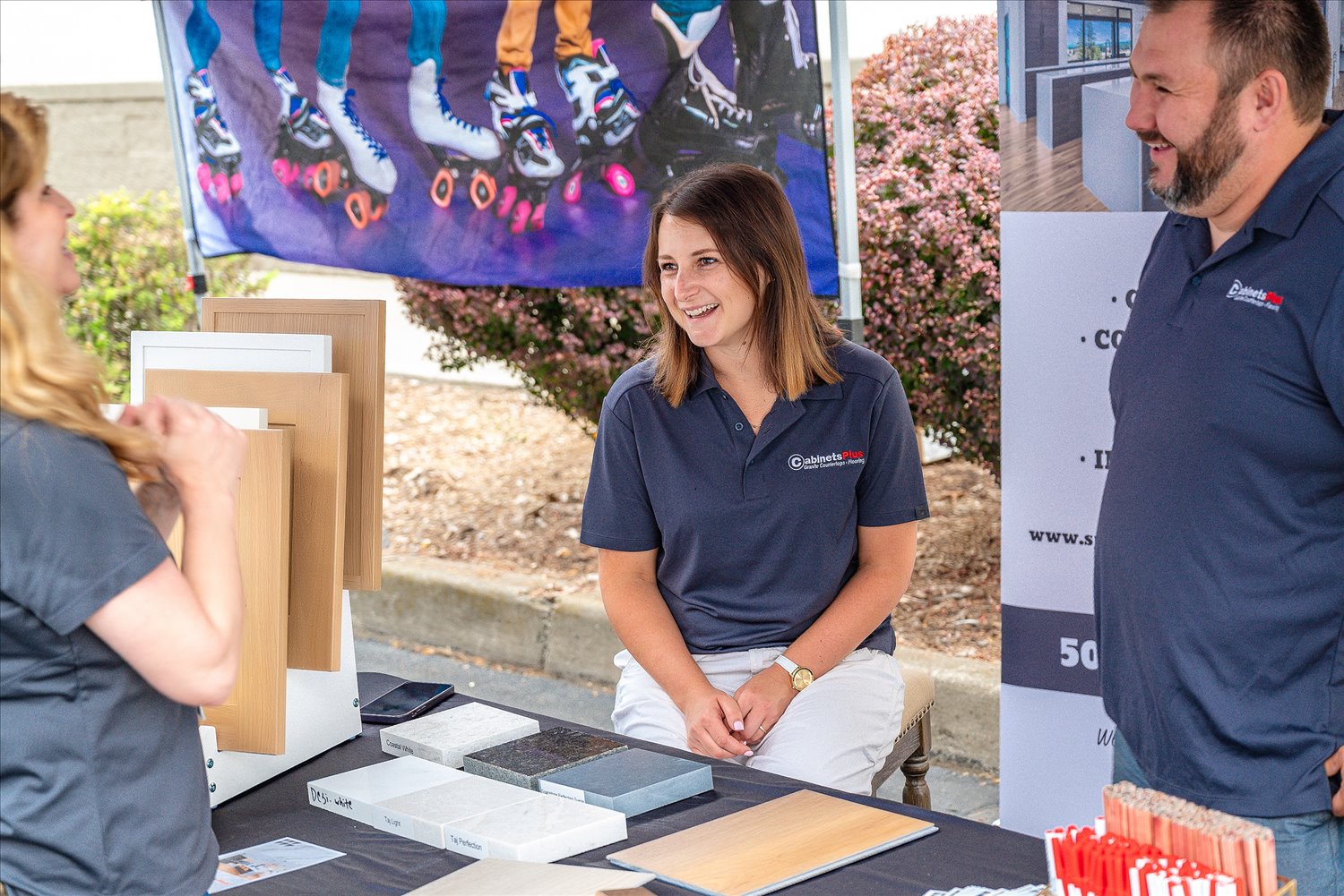 A local business owner talks with visitors at her table during an SSA community event.