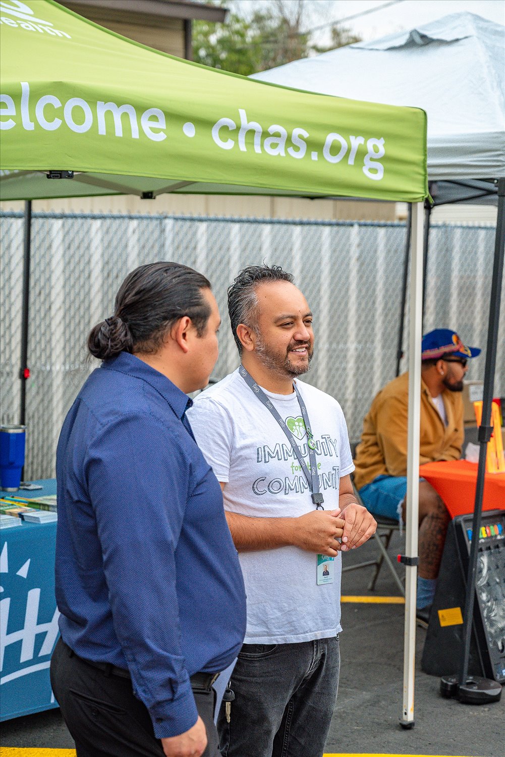 Representatives of a partner organization talk with visitors at their tent during an SSA community event.