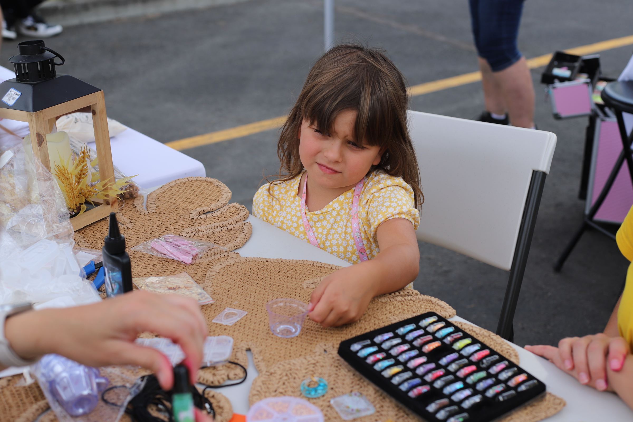 A young girl works on a hands-on craft activity at an SSA community event.