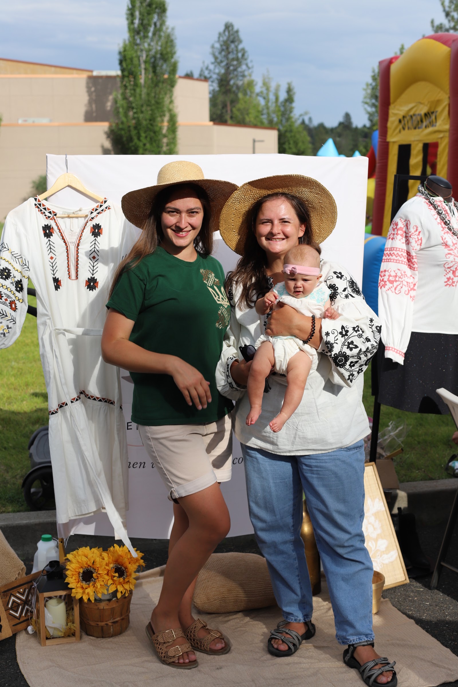 A local business's traditional clothing display at a community vendor booth during UA Fest.