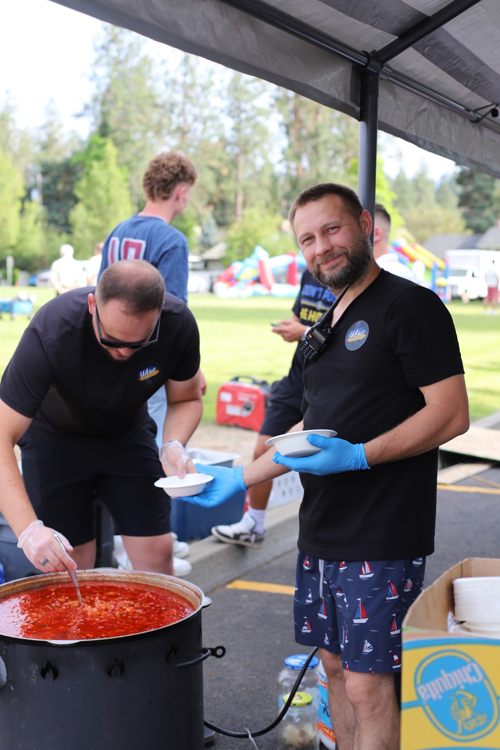 Volunteers cook and serve food at the UA-Fest community celebration.
